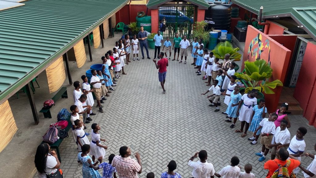 Students gather to sing and share a meal in the courtyard at B.A.S.I.C.S. International prior to receiving afterschool tutoring. B.A.S.I.C.S. International, a nonprofit organization located in Accra, Ghana, graciously hosted students from Auburn University as they conducted field research in October 2019.